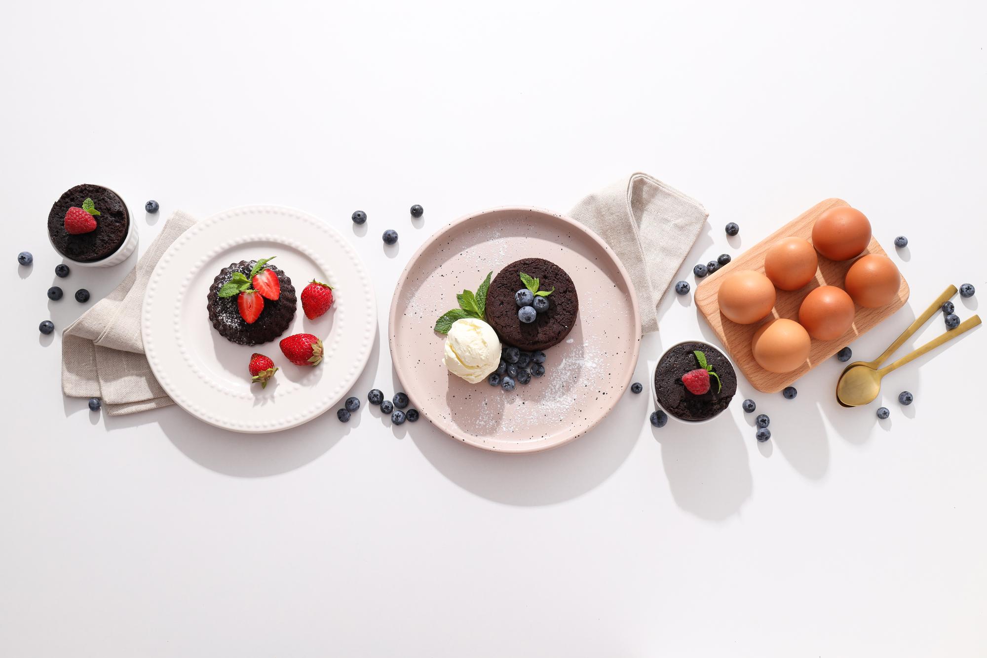 Array of plated desserts on dark table